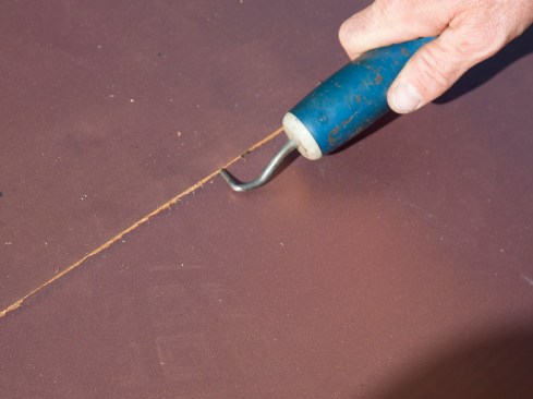 A properly welded seam has the characteristic “bleed” along the seam edge, where molten material is squeezed out ahead of the seam roller. That tells you that you have a fully welded bond; voids or fishmouths are easily seen. Smaller fishmouths can be re-welded, while larger ones are usually patched. A pointed, cotter pin extractor is used as a seam probe to check for any loose spots along the welded seam that would void the manufacturer’s warranty.