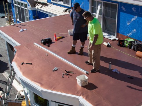 On the perimeter edge, lengths of PVC-clad heavy-gauge stainless steel drip edge were installed on top of the roof’s membrane. The drip edge comes with a weldable PVC coating, which allows for the bonding of cover strips flashing. The author usually installs galvanized and stainless steel drip edge, though copper can be special ordered (the copper has to be pre-made and sent out to have a plastisol PVC coating applied to allow for membrane bonding).