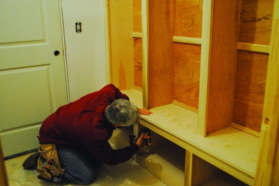 The base also screws to the wall, and then pocket screws join the two sections together.