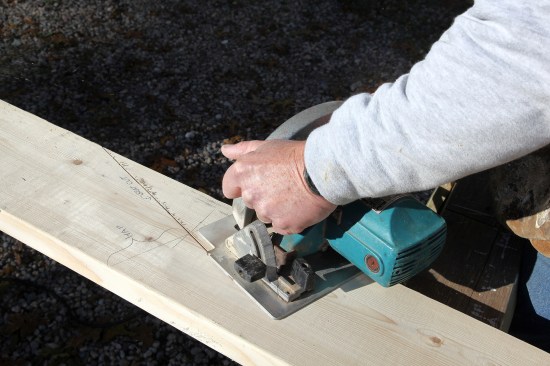 A circular saw makes the plumb cut for the birdsmouth just up to the layout line. The cuts are finished with a hand saw to avoid over cutting and weakening the rafter.