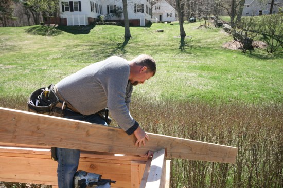 At the other end the crew member sets the edge of the seat cut on the layout line.