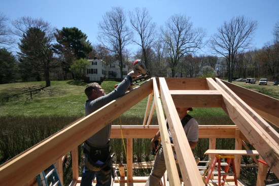 A nail driven through the top of the hip rafter secures it in place. 