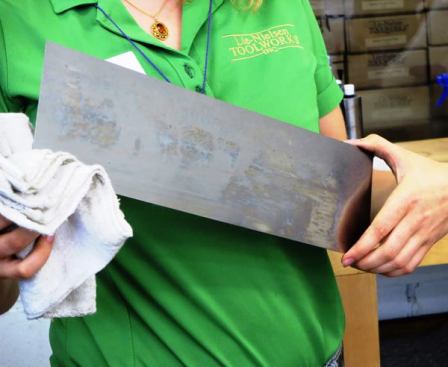 This will soon be a backsaw blade. It arrived as part of a coil of metal, was cut to shape, and will have holes drilled in it to hold a handle and back.