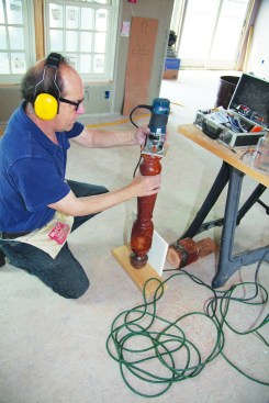 Here, the author shaped one of the two smaller newels with a series of passes to make a new shoulder, turning the post while holding the router stationary.