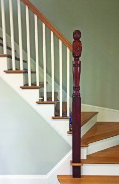 A new bottom block raised the newel and handrail height to comply with code. It also created a strong connection to the new stair framing.