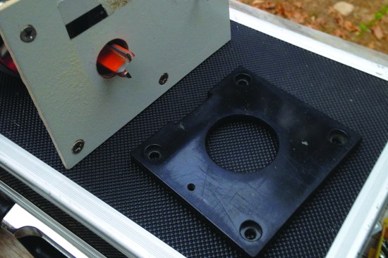 The author made a temporary router base plate out of Masonite.