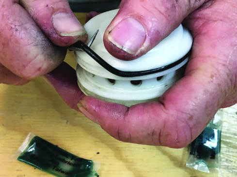 Next, remove the outer O-rings from the piston head valve.