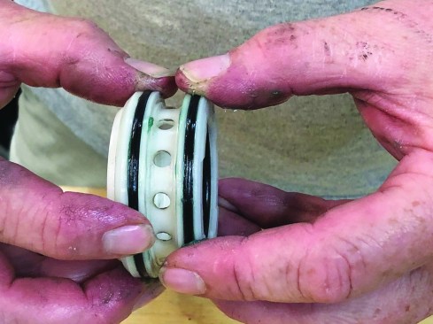 As before, smear lubricant on the replacement rings and slip them into the outer grooves on the valve. Rotate the valve with your fingers on the O-rings to ensure that the lubricant is distributed evenly.