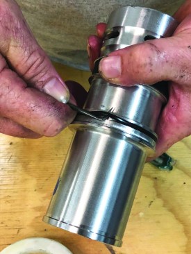 The cylinder sleeve that holds the driverpiston assembly has two O-rings to replace. Pull the smaller ring from its groove.
