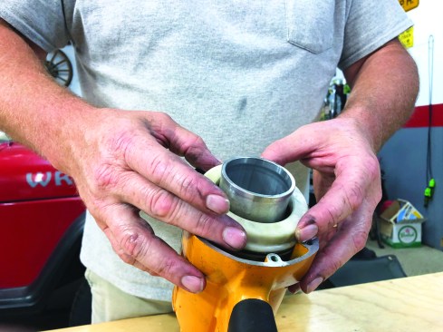 Next, slide the cylinder ring into place over the sleeve, pushing the ring as far down as possible. Finally, slip the cylinder seal over the top of the cylinder assembly.