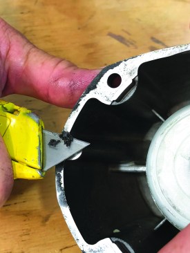 The cylinder cap installs on the nailer frame with a gasket that needs to be replaced with every rebuild. First, though, carefully scrape off any residue from the edge of the cap, using a sharp utility-knife blade.
