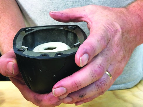 The cap for this nailer has guides that align the gasket properly on the cap and keep it in place during reassembly.