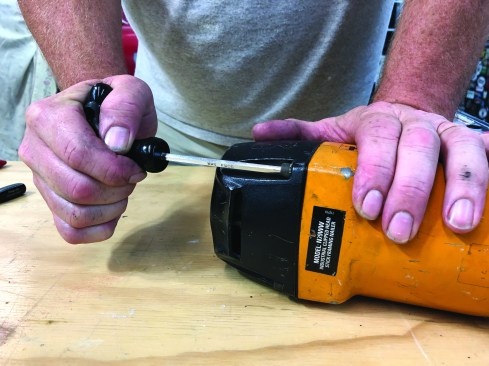 When the cap is in contact with the frame evenly around its entire perimeter, tighten the machine screws to a predetermined torque. For this nailer, the manufacturer recommends 25 to 40 pounds of torque.