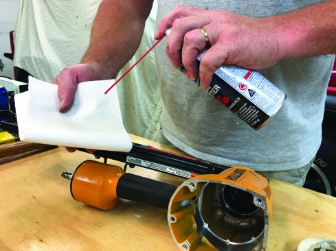 On a clean paper towel, spray a cleaner-lubricant, such as Gum Cutter (berkebileoil.com), that will not have an adverse effect on the internal nailer parts.