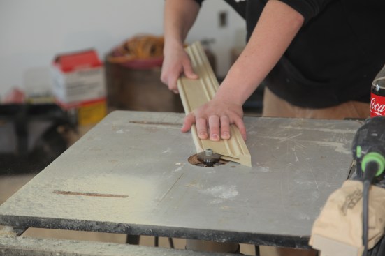 To align the casing pieces at the corners, the crew uses biscuit joinery. A slot is cut into each side of the mating corner pieces and a biscuit spline inserts into the slots to reinforce the joint and to align the pieces. 