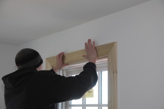 After cutting the head casing to length, the carpenter dryfits the casing pieces together with dry biscuits to align the pieces at the corners.