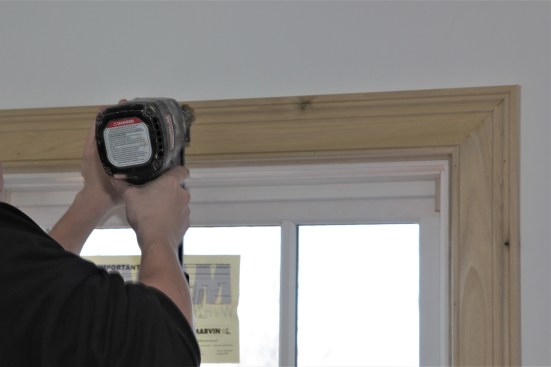 With the corner joints satisfactory, the carpenter drives finish nails to hold the head casing in place. 