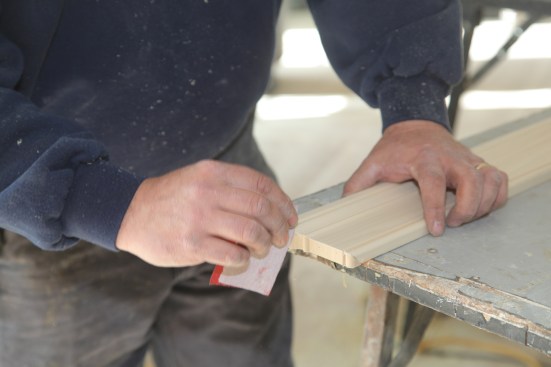 When the glue has set, go back and sand the edge smooth with fine sandpaper, taking care to maintain a crisp square corner where the return meets the apron.