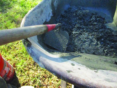 For mixing concrete in a wheelbarrow, a conventional hoe doesn’t work well, because its square corners don’t fit into the corners of the tub.