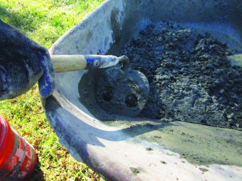 A mortar hoe has rounded corners and holes in the blade for easier and more thorough mixing.