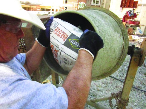 He then adds premixed concrete.