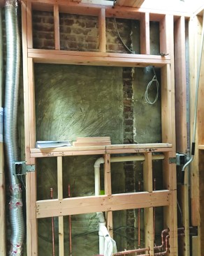 New 2x6 wall framing and solid blocking were needed for the wall-hung vanity and recessed cabinet above ...