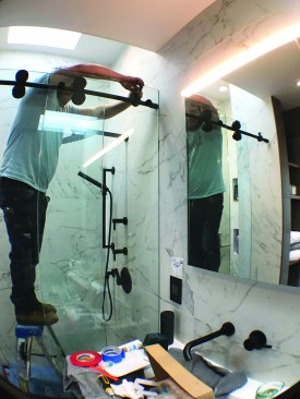Barn door–style hardware for the shower door