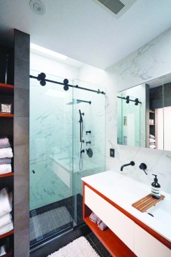 The frameless bypass door provides easy access to the shower.
