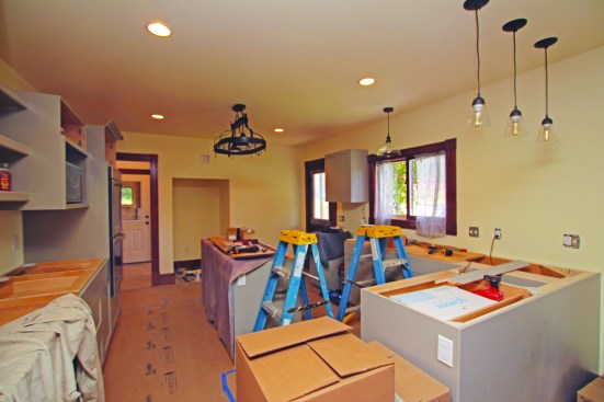 Cabinets are being installed in the new kitchen