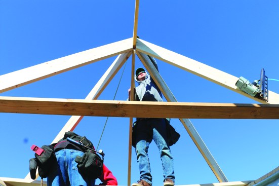 Starting at one end of the semicircle, the crew installs the rafters that divide the arc into eighths and then into sixteenths.