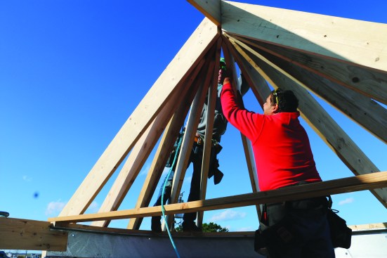 Finally, the crew installs the rafters that divide the sixteenth spaces into “thirty-second” spaces. Instead of trying to cut a long point at the top end of the thirty-second rafters, the crew butt-cuts the tops and toenails them into place.