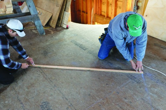A ripping of 2-by material is used to trace the rafters one by one.