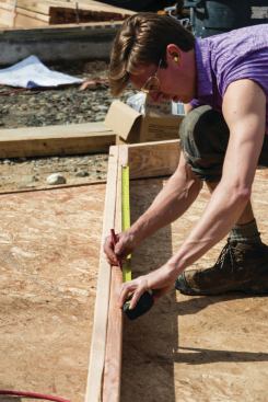 Typically, we lay out and install the king studs for any window and door openings first. We always lay out the uphill (long-point) side of the stud so that we're cutting to the "sharp" point of the bevel. Using the Construction Master calculator, we enter that number as the RUN in the calculator and then find the DIAG. We measure the distance along the underside of the top plate.