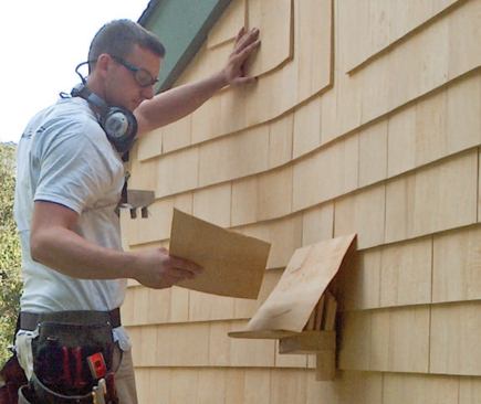 "Mules" that slip underneath the installed siding are handy for holding extra shingles.