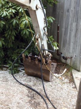 An excavator parked at the top of the hill provided hydraulic power.