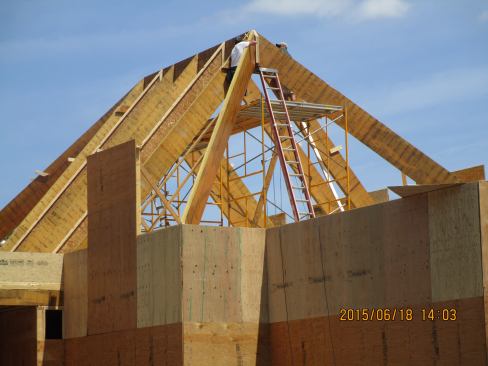 A view of the fourteen-pitch hip roof assembly under construction.