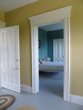 Here is one of the third floor doorways with the heavy rounded casing profile. The head casing had to be thick to overlap the jamb casing below, but the height of the head casing with its cornice detail seems to be larger than proper proportions would dictate.