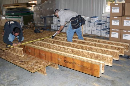 For this project, the crew preassembled second-story floor frames in the shop in 8-foot-wide sections.