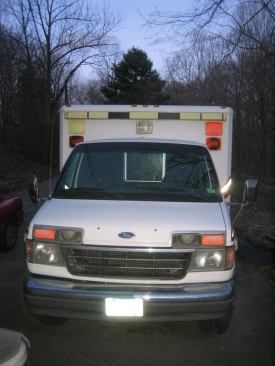 When the van came from the factory "ambulance" would have been printed in reverse on the hood (so it could be read in a rear-view mirror). Those markings are usually decals so they are easily removed when the vehicle is converted to non-emergency use.