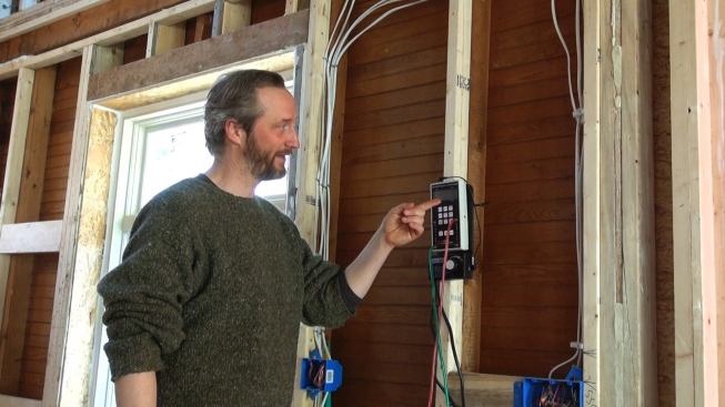 Harvey Johnson explains the blower door control display.
