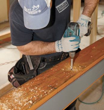 They repeated the process on the other side, then flipped the beam over again and drilled the bolt holes back through the full assembly.