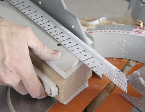 A good fit at the miters is important, so I use a jig to hold the flexible bead in position when cutting it with a miter saw.