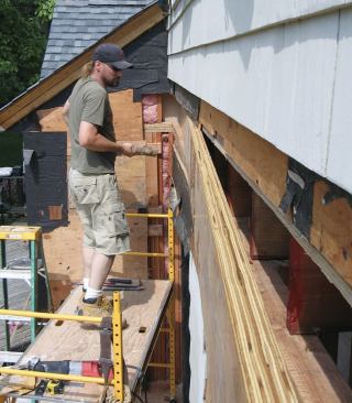 With most of the floor system still supported by the wall framing, this gave us a little extra peace of mind as we angled the microlam into place and used our sledgehammer to pound it tight against the joist ends.