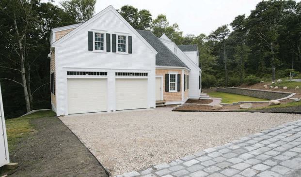 A dry-laid masonry retaining wall and hard-surfaced walkways, installed as soon as possible after the completion of foundation work, provided early curb appeal and a mud-free site throughout the rest of the project.