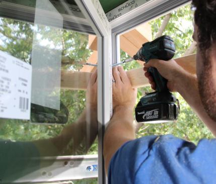 Setting the self-tapping, structural lag screw (supplied with the window unit) in place. Windows are pre-drilled at the factory to accept three lags in each side and two in the head rail. Plastic caps for the lag screws are also supplied.