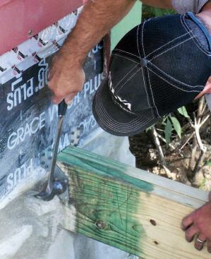 Cut ends of the pressure-treated lumber were soaked with wood preservative, and metal hangers were added for an extra measure of stability.