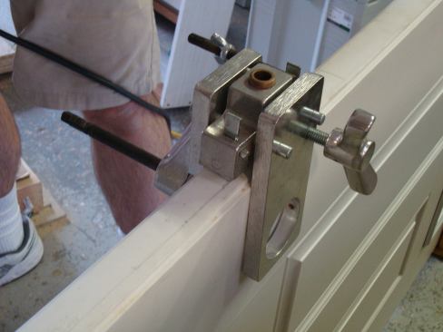 This jig made by Classic Engineering lets you cut the holes for the lockset and deadbolt, keeping them perfectly aligned with the edge bore holes. Guides in the jig ensure that the bits stay perfectly in line.