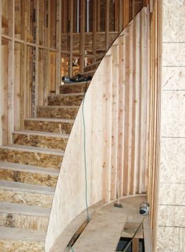 I cut 2x6 studs, beveled at the top to match the slope, and glued and nailed them to the elliptical plate at about 6 inches on-center where the radius was tight and 8 inches on-center elsewhere.