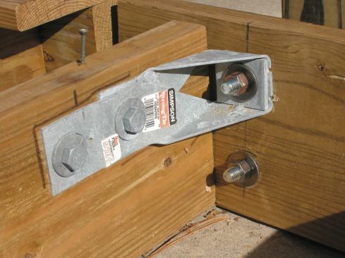 The authors tested the HD2A connection with the post installed both inside and outside the band joist; both configurations withstood the full test load. At 200 pounds, the sample post shown above deflected but the connection held; at 650 pounds, with the post still holding, the test was ended so as not to damage the test machine.