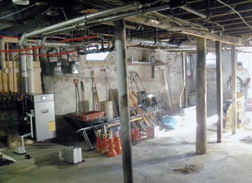 The home's central girder had been unprofessionally shored over the years with steel posts, pressure-treated 4x4s, and even a cedar log.